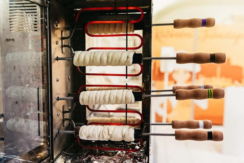 Budapest: Hungarian Chimney Cake Workshop in the City Center - The baking station: how the dough, cone, and sugar come together
